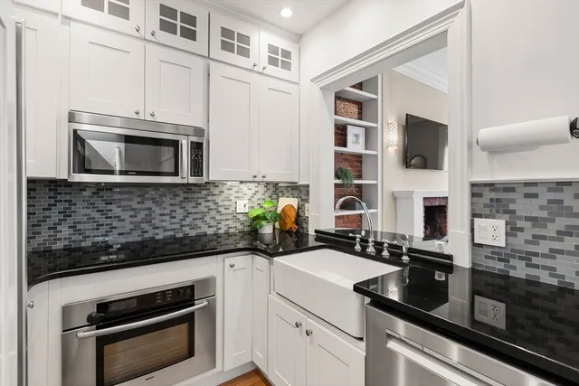 a kitchen with stainless steel appliances a stove microwave and cabinets
