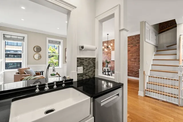 a bathroom with a granite countertop sink and a bathtub