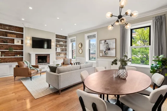 a living room with fireplace furniture and a flat screen tv