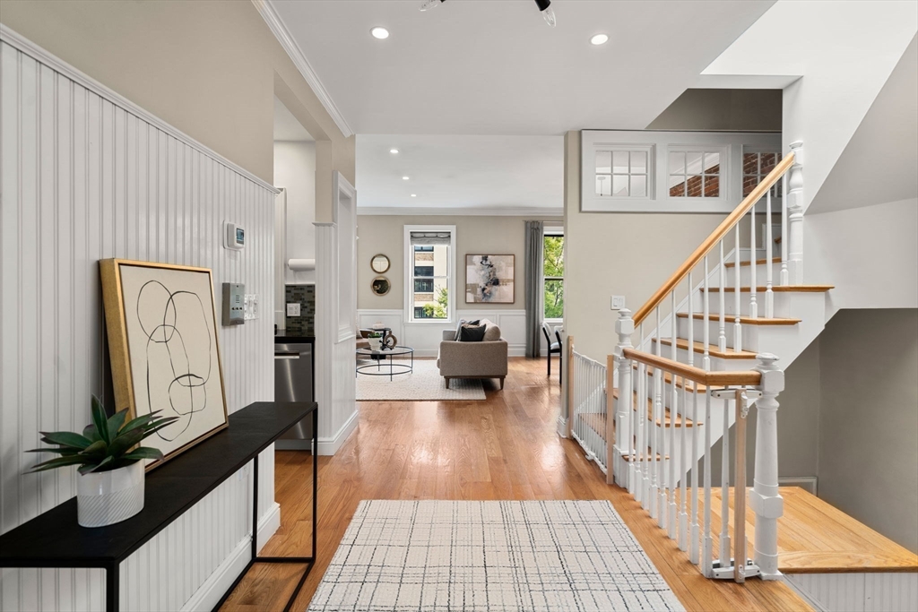 82 Berkeley Street, Unit 5 Boston, MA 02116 - Photo 22 of 32 a view of a hallway with wooden floor and staircase