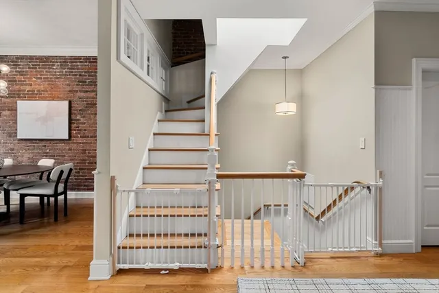 a view of entryway and hall with wooden floor