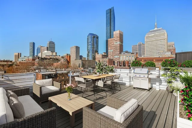 a view of roof deck with patio and outdoor seating