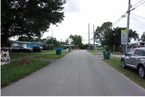 a view of a street with a car parked in the background