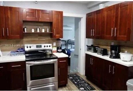 a kitchen with stainless steel appliances granite countertop a stove and a refrigerator