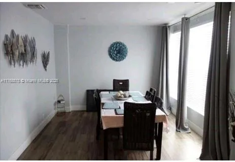 a view of a workspace with furniture and wooden floor