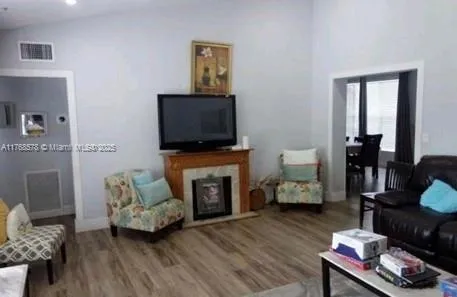 a living room with furniture and a fireplace or television