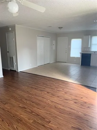 a view of wooden floor and windows in a room