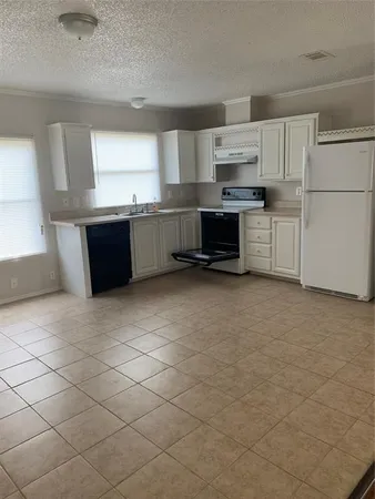a kitchen with stainless steel appliances a sink and a refrigerator