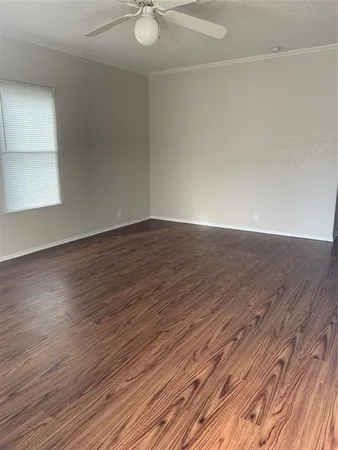 a view of an empty room and wooden floor