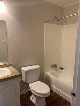 a white toilet sitting next to a bathroom sink