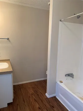 a bathroom with a bathtub and shower