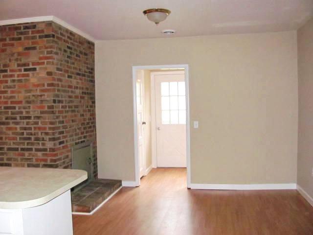 50 Sycamore Landing Road Waverly, TN 37185 - Photo 13 of 20 The dining room is also accented with a brick wall that adds to the country charm of the home. Just behind the dining area is a utility room and back door exit.