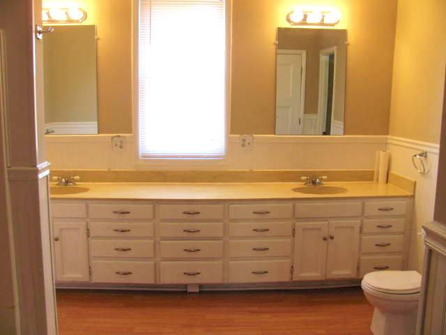 50 Sycamore Landing Road Waverly, TN 37185 - Photo 17 of 20 This spotless bath has a lovely window, bead board half wall, double vanities and ample counter and cabinet space. It has a combo tub with shower as well as extra storage in the linen closet.
