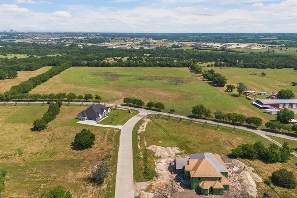 an aerial view of residential houses with outdoor space and ocean view