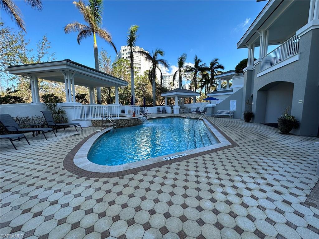 325 Dunes Boulevard, Unit 306 Naples, FL 34110 - Photo 30 of 40 a view of a swimming pool with sitting area