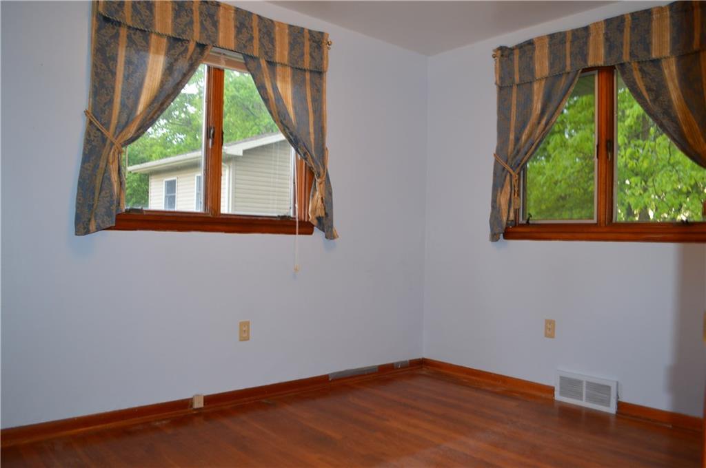 557 Shenango Road Beaver Falls, PA 15010 - Photo 12 of 25 The second bedroom offers a view through either window, hardwood flooring.
