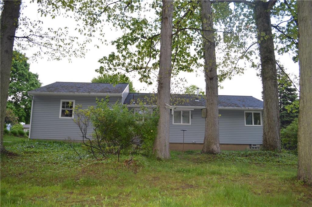 Rear view of the level entry ranch home.  Wooded lot offers tranquility and shade!