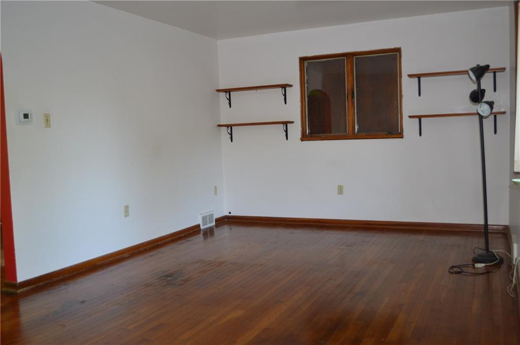 557 Shenango Road Beaver Falls, PA 15010 - Photo 22 of 25 Warm hardwood floors and trim in the living room. A good size that offers furniture options!