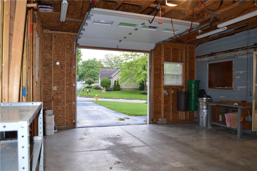 9-foot garage door accommodates your oversized vehicle.  Concrete floor, great work and storage space.  Even a doggy door at the side/rear (currently covered).