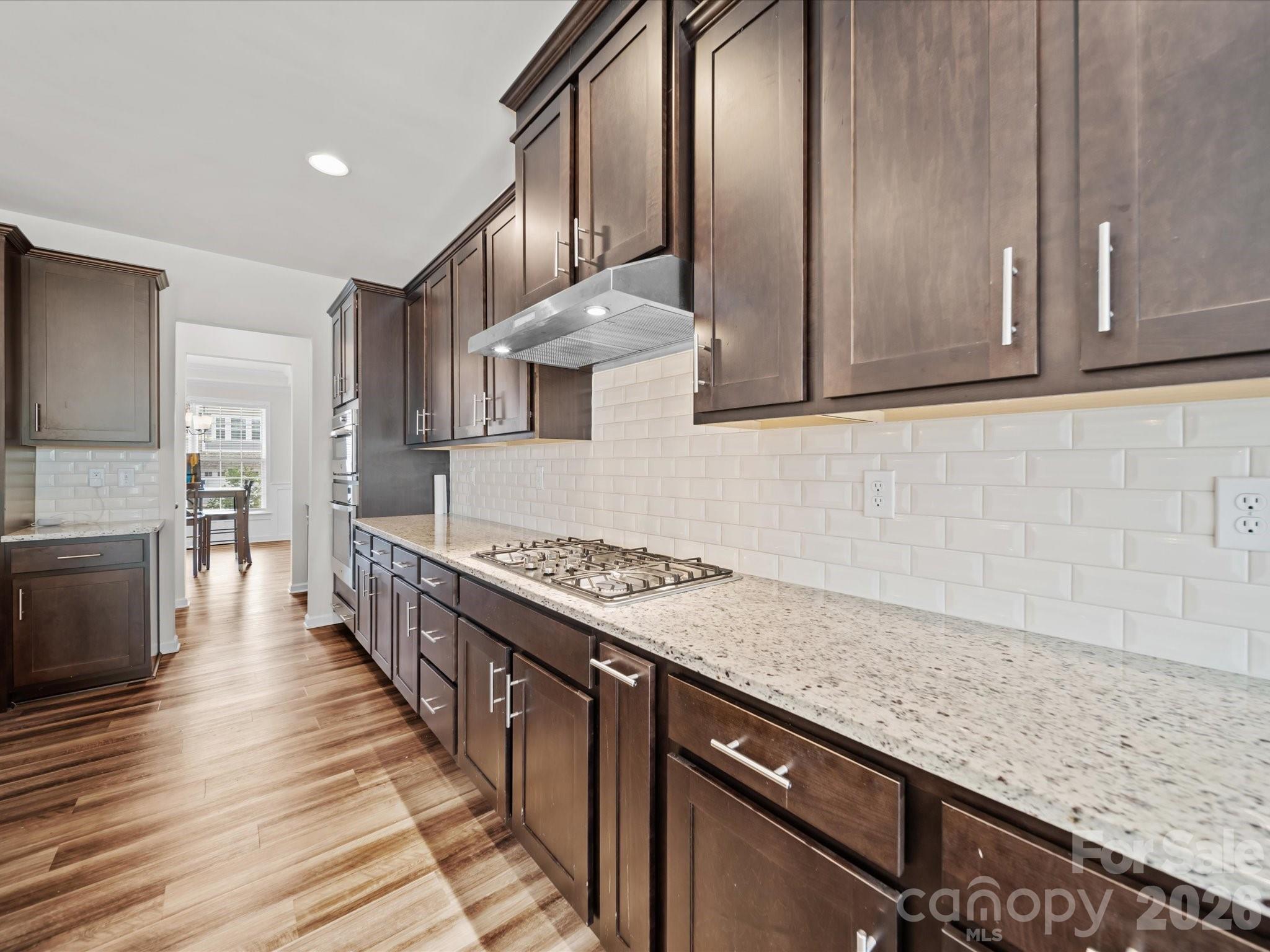 9582 Creighton Road Northwest Concord, NC 28027 - Photo 11 of 43 a kitchen with stainless steel appliances granite countertop a sink stove and cabinets