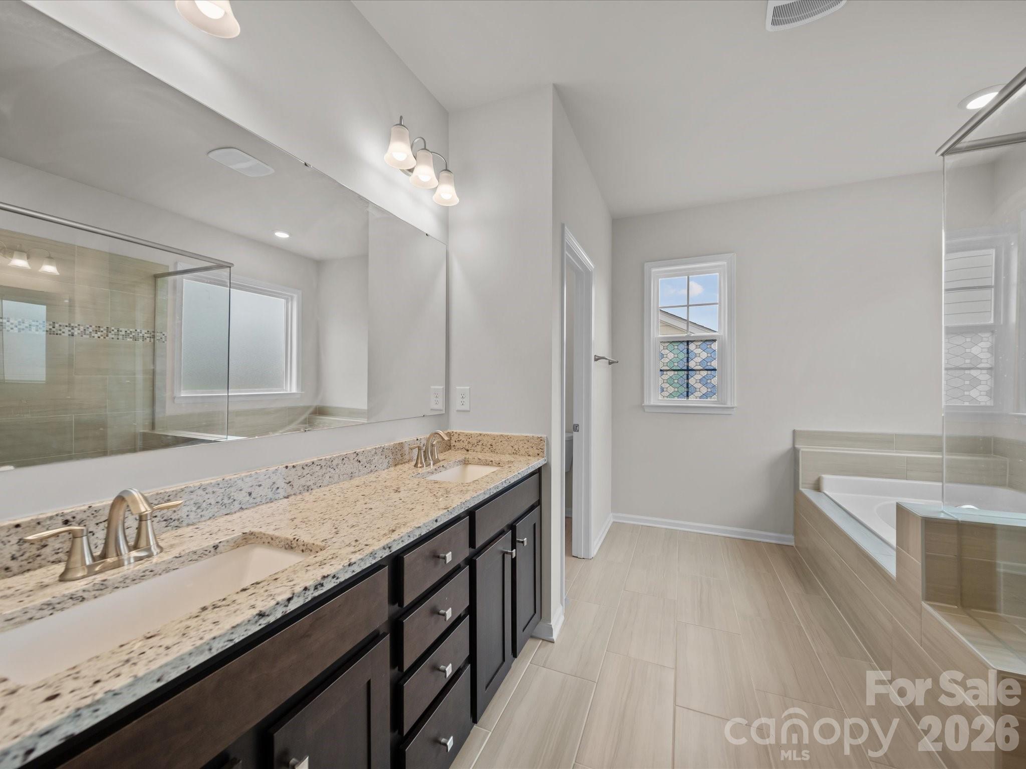 9582 Creighton Road Northwest Concord, NC 28027 - Photo 20 of 43 a bathroom with a granite countertop double vanity sink and mirror
