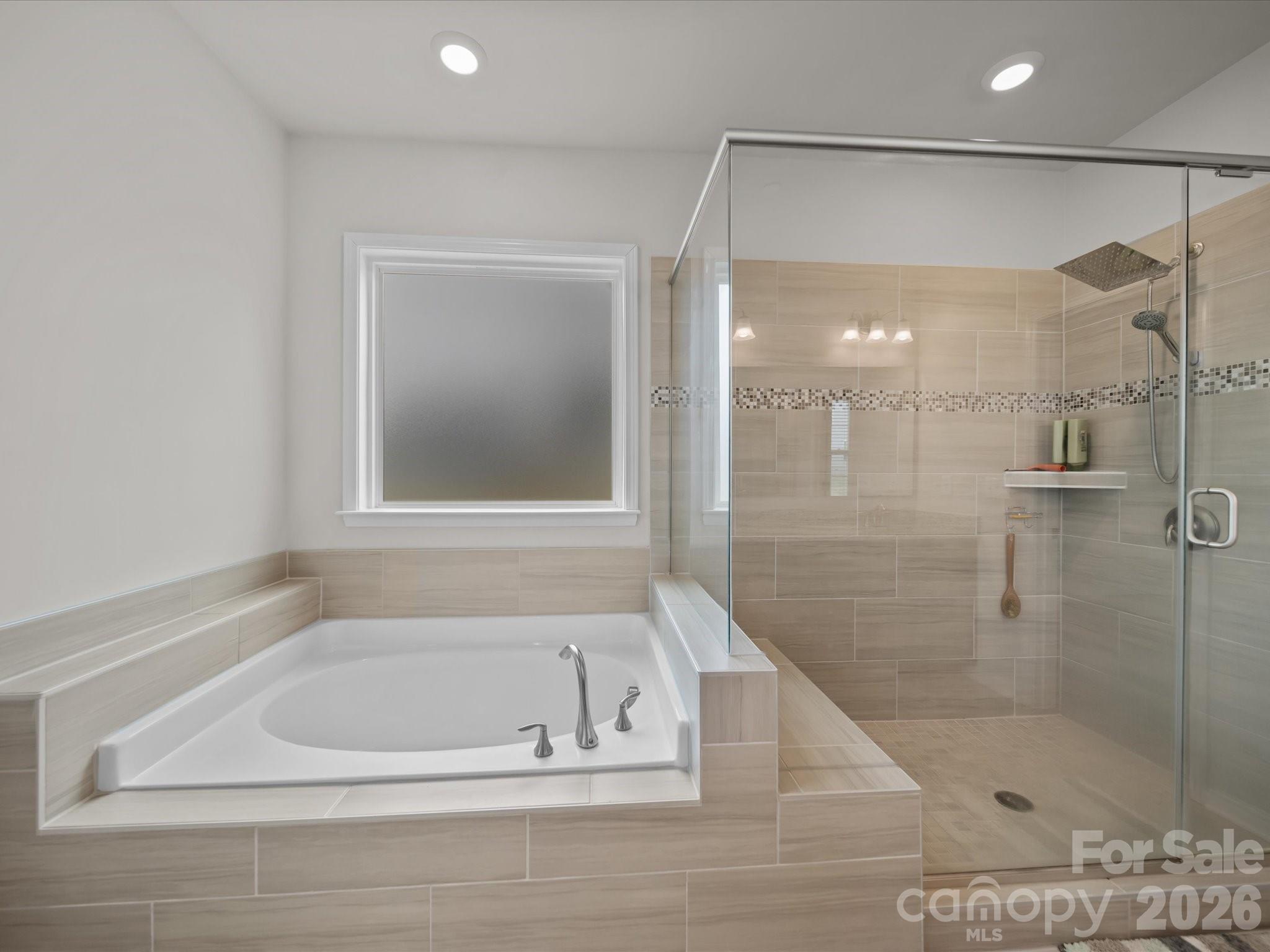 9582 Creighton Road Northwest Concord, NC 28027 - Photo 21 of 43 a bathroom with a bathtub and a shower