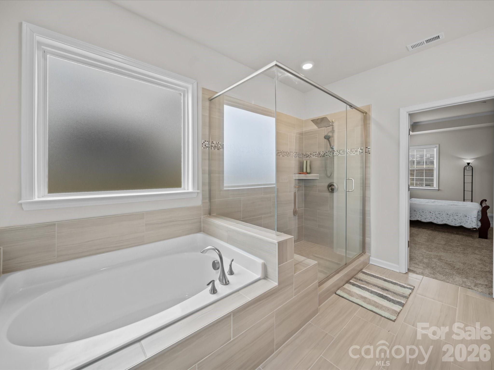 9582 Creighton Road Northwest Concord, NC 28027 - Photo 22 of 43 a bathroom with a bathtub and a shower
