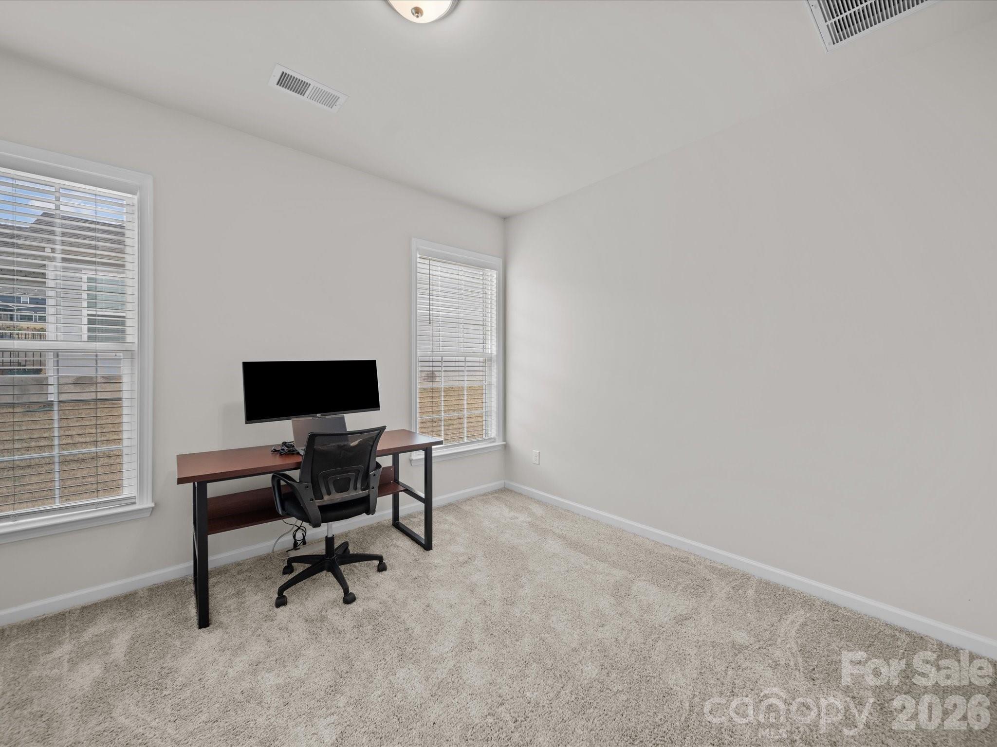 9582 Creighton Road Northwest Concord, NC 28027 - Photo 24 of 43 a view of a workspace with furniture and a window