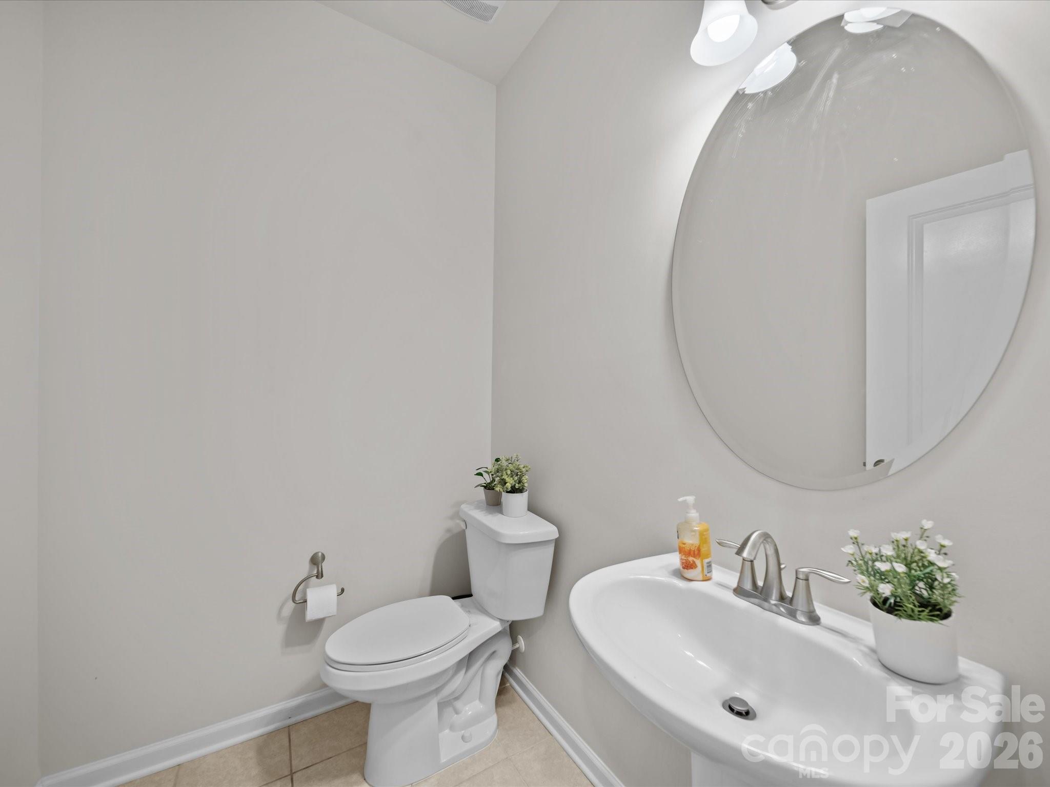 9582 Creighton Road Northwest Concord, NC 28027 - Photo 27 of 43 a bathroom with a sink mirror and toilet