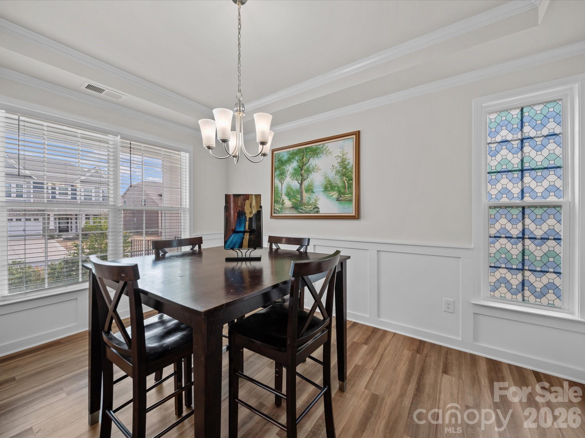 9582 Creighton Road Northwest Concord, NC 28027 - Photo 5 of 43 a view of a dining room with furniture wooden floor and chandelier