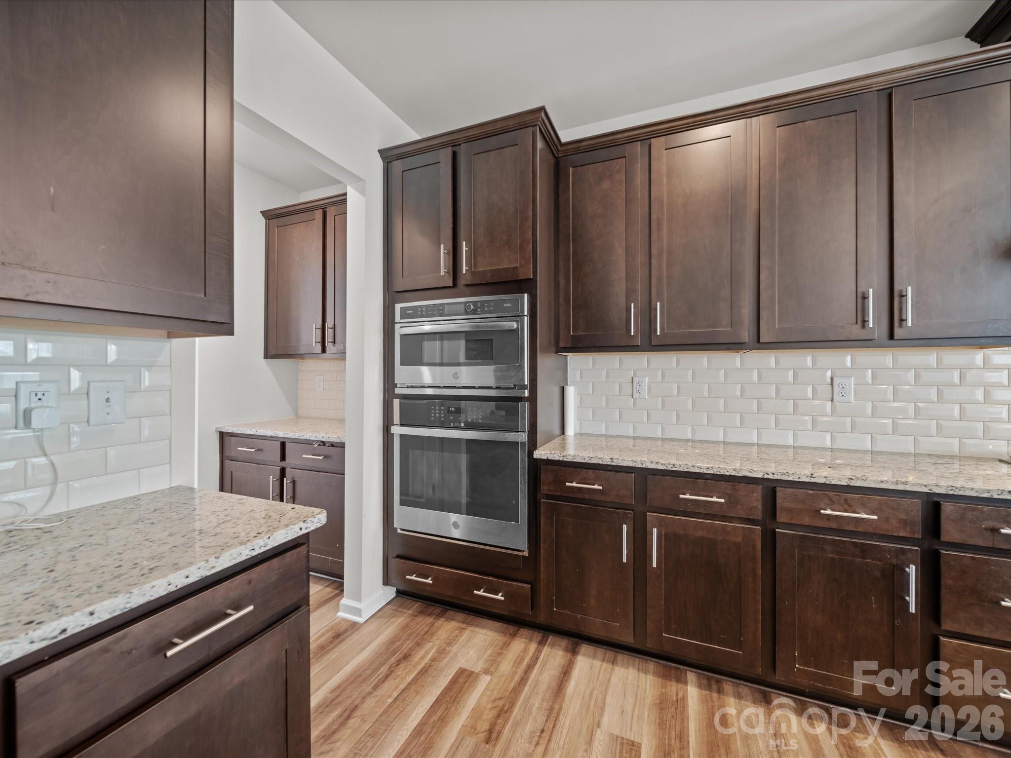 9582 Creighton Road Northwest Concord, NC 28027 - Photo 8 of 43 a kitchen with granite countertop a stove and cabinets