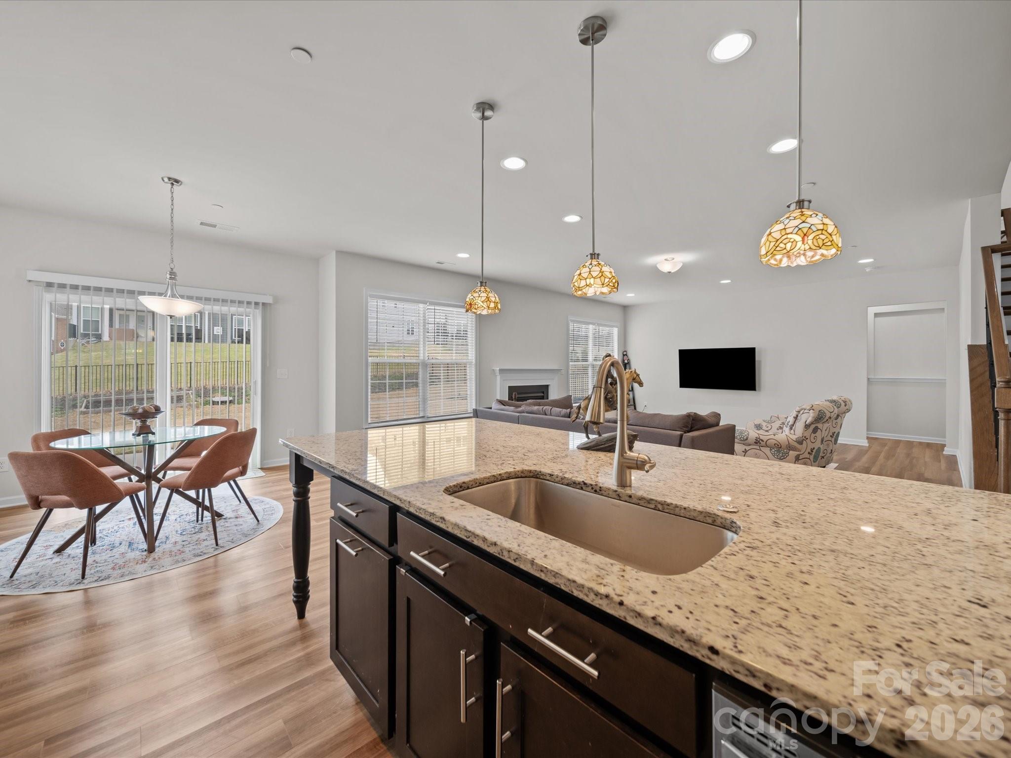 9582 Creighton Road Northwest Concord, NC 28027 - Photo 9 of 43 a kitchen with granite countertop a sink a counter space appliances and cabinets