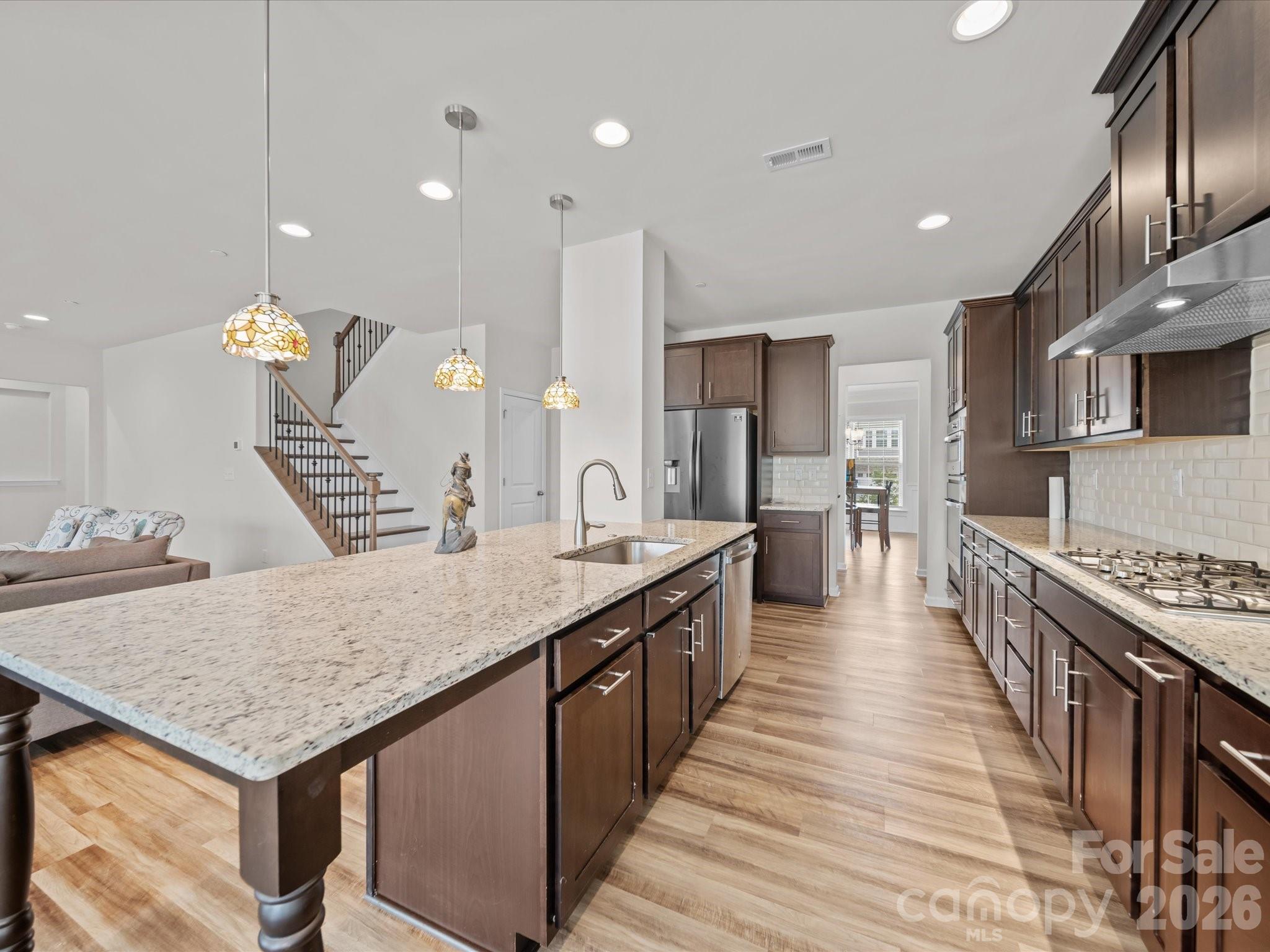 9582 Creighton Road Northwest Concord, NC 28027 - Photo 10 of 43 a kitchen with counter space and wooden floor