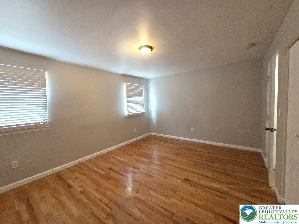 1747 Schoenersville Road Bethlehem, PA 18018 - Photo 10 of 13 Warm hardwood floors and plentiful window light define this welcoming bedroom space.