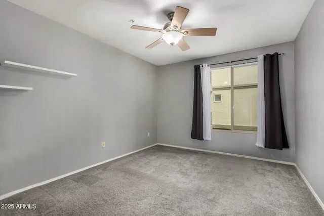 wooden floor in an empty room with a bathroom