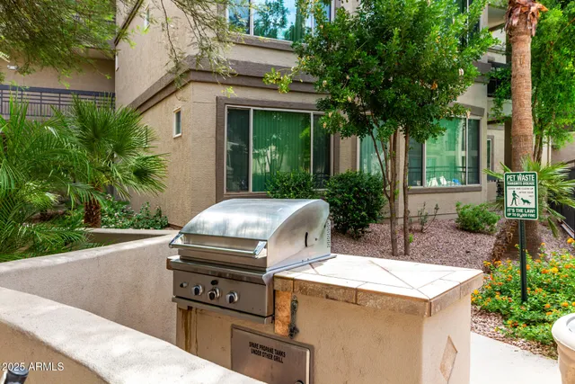 a view of a white building with swimming pool and furniture