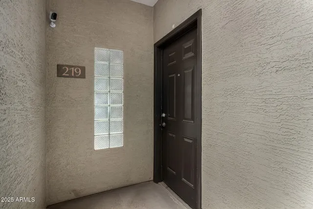 an empty room with a window and a ceiling fan