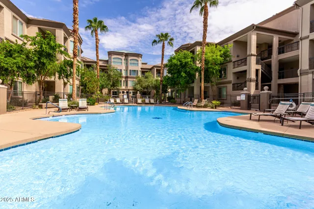 a view of a swimming pool with a lounge chairs