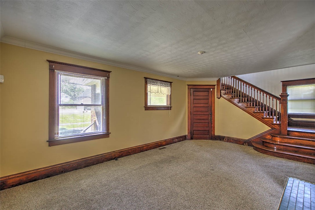 340 North Edward Street Decatur, IL 62522 - Photo 3 of 20 a view of an empty room with stairs and windows