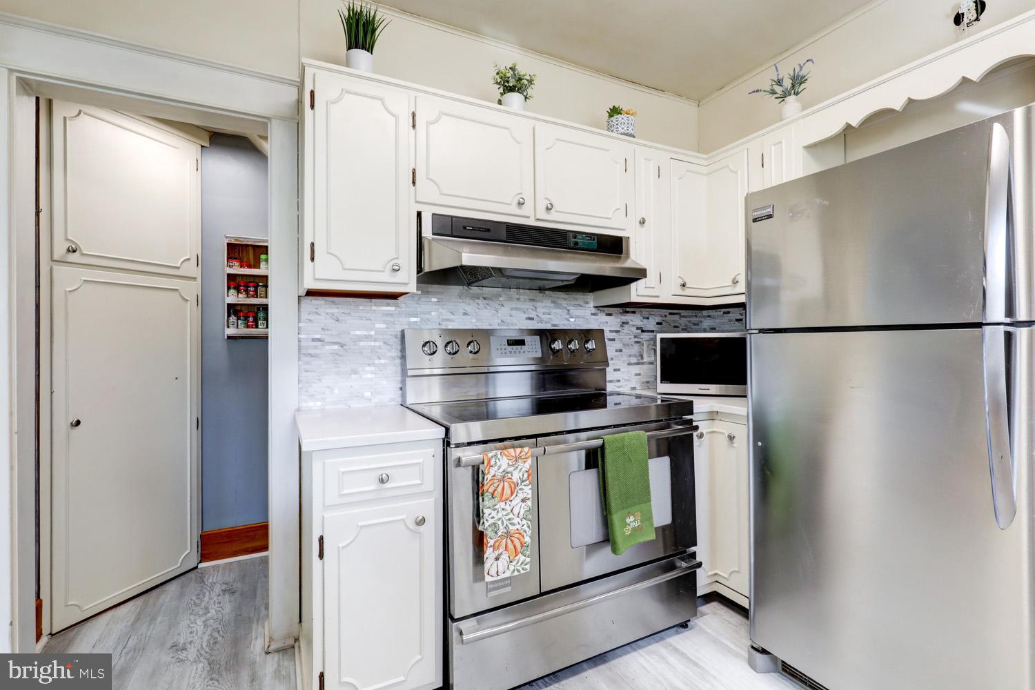 483 Angora Road Reading, PA 19606 - Photo 21 of 73 a kitchen with stainless steel appliances a refrigerator a stove a microwave and cabinets