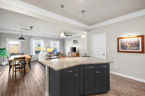 a living room with furniture dining table and a flat screen tv