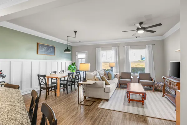 a living room with furniture and a wooden floor
