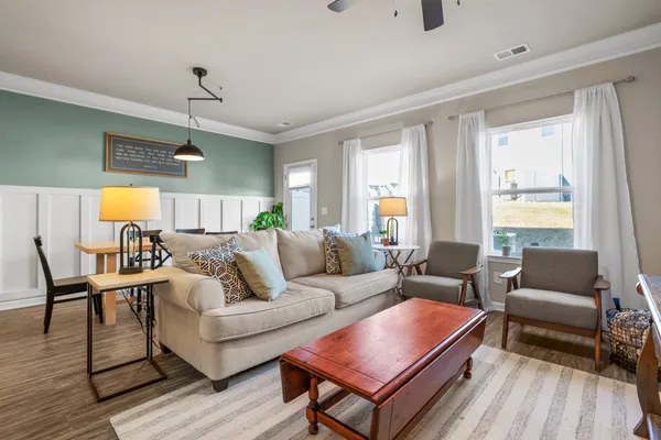 a living room with furniture a fireplace and a flat screen tv