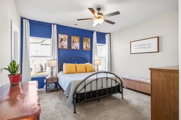 a bedroom with a bed and a chandelier