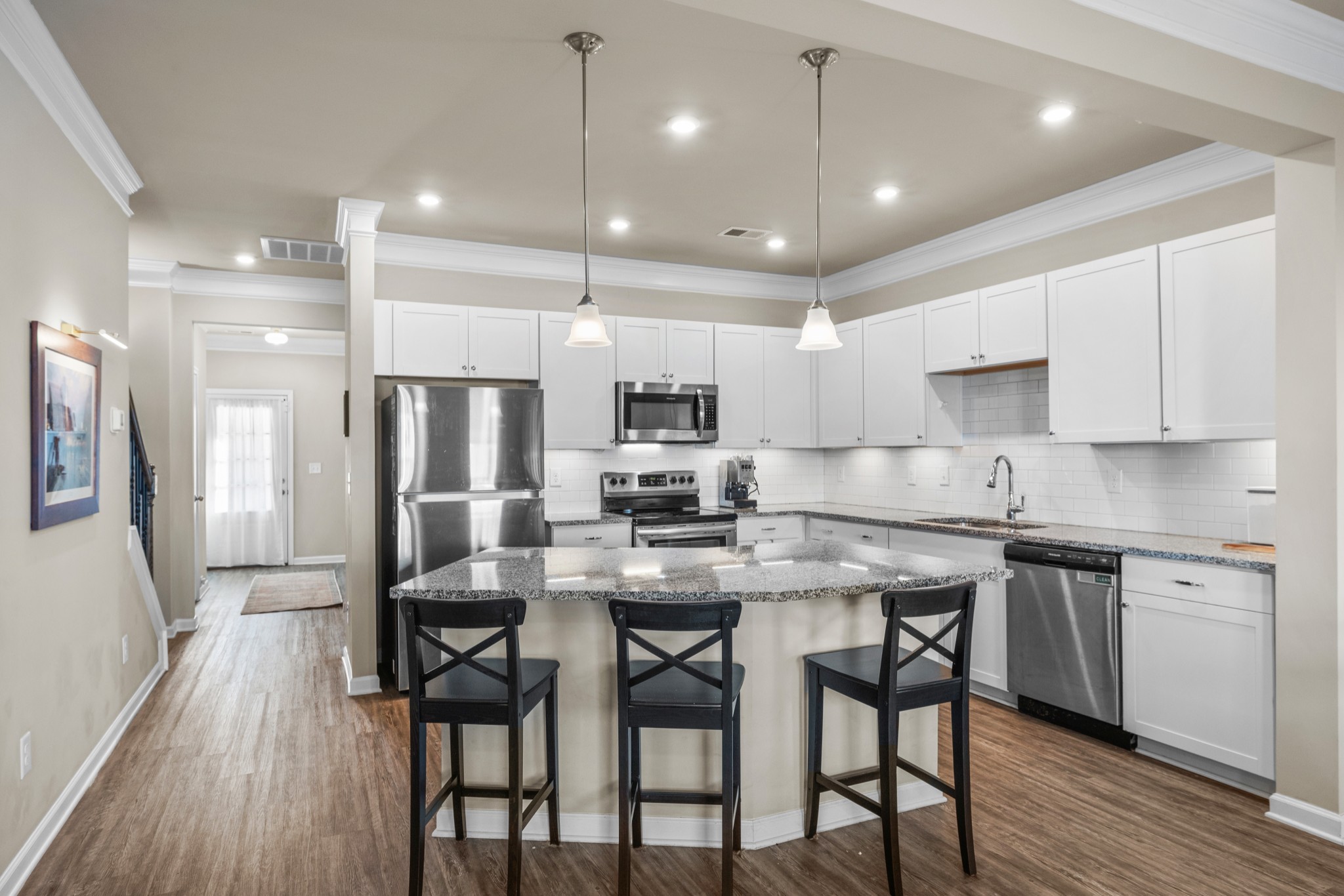 2806 Dixie Road Columbia, TN 38401 - Photo 8 of 28 a kitchen with stainless steel appliances kitchen island granite countertop a dining table chairs refrigerator and microwave