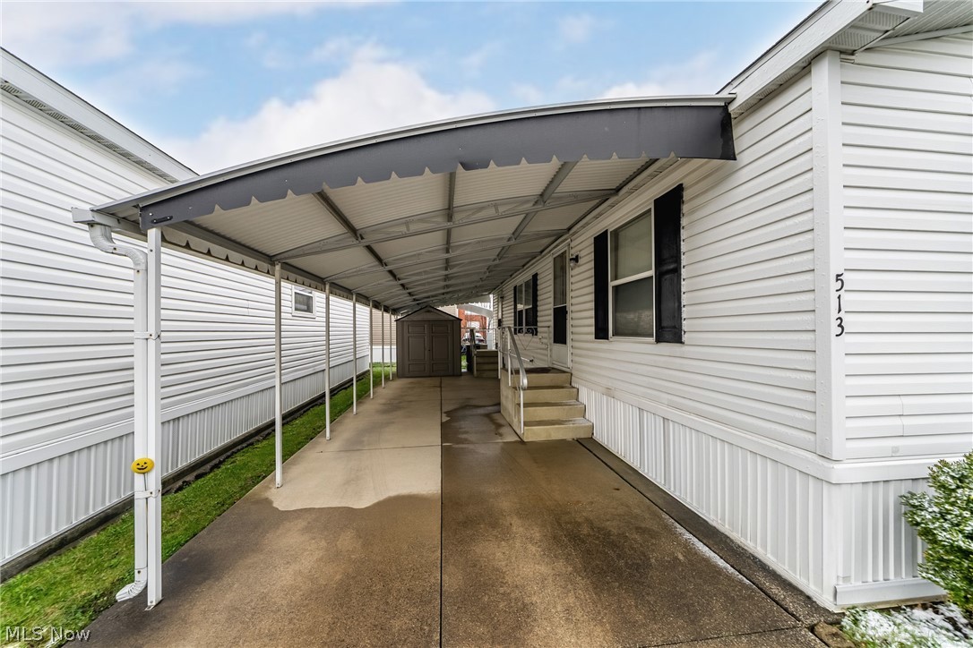 2700 Brookpark Road, Unit 513 Cleveland, OH 44134 - Photo 4 of 25 View of patio featuring a shed, a carport, and entry steps