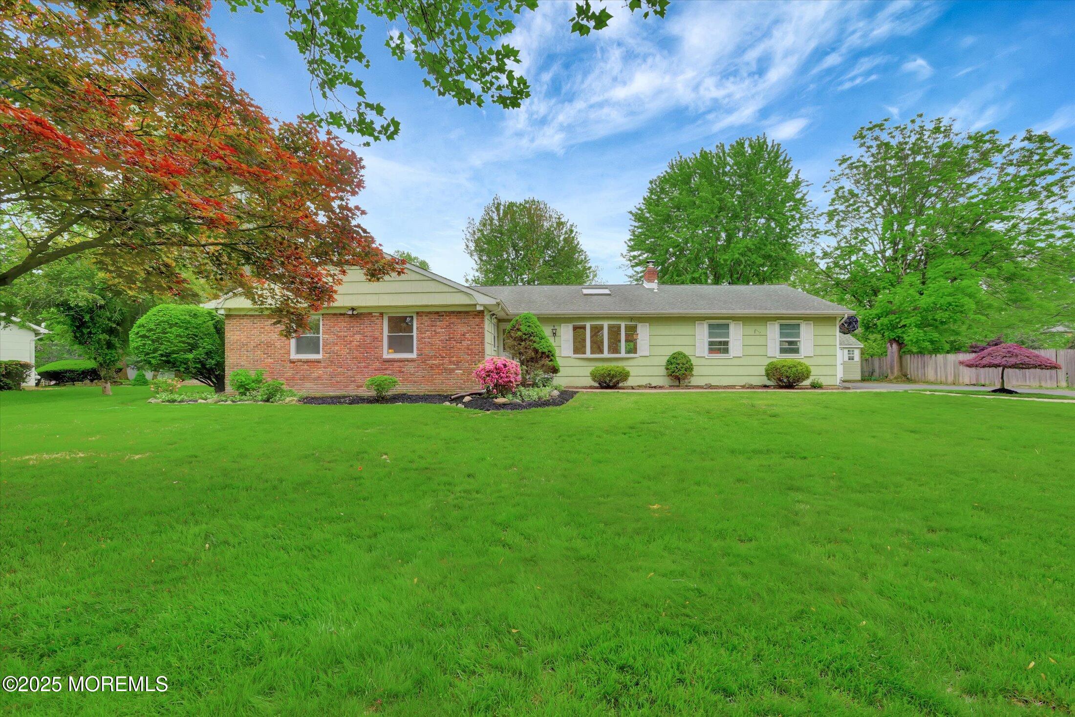 a front view of house with yard and green space