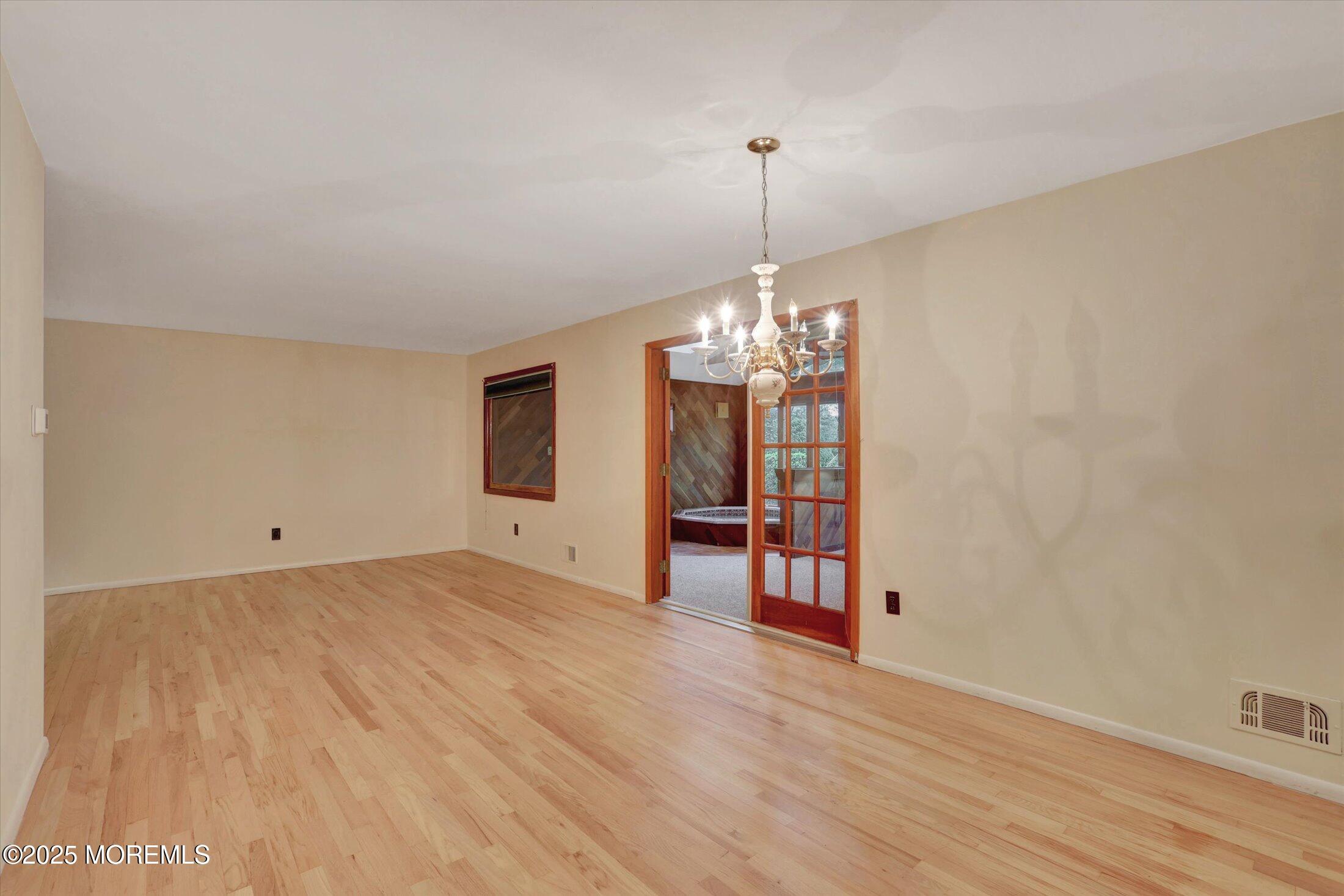 159 Koster Drive Freehold, NJ 07728 - Photo 14 of 37 a view of a room with wooden floor chandelier and a window