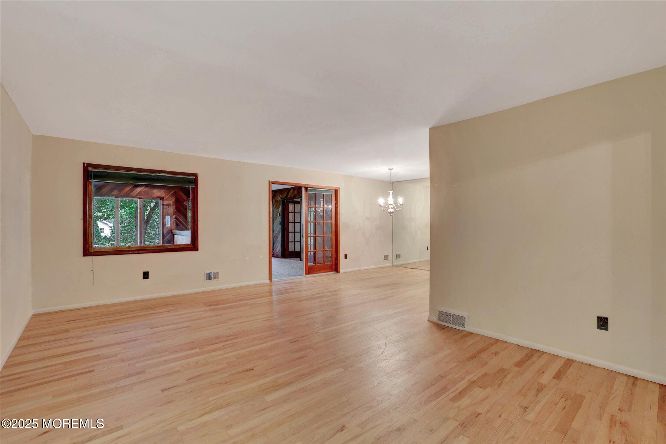 159 Koster Drive Freehold, NJ 07728 - Photo 16 of 37 a view of an empty room with wooden floor and window