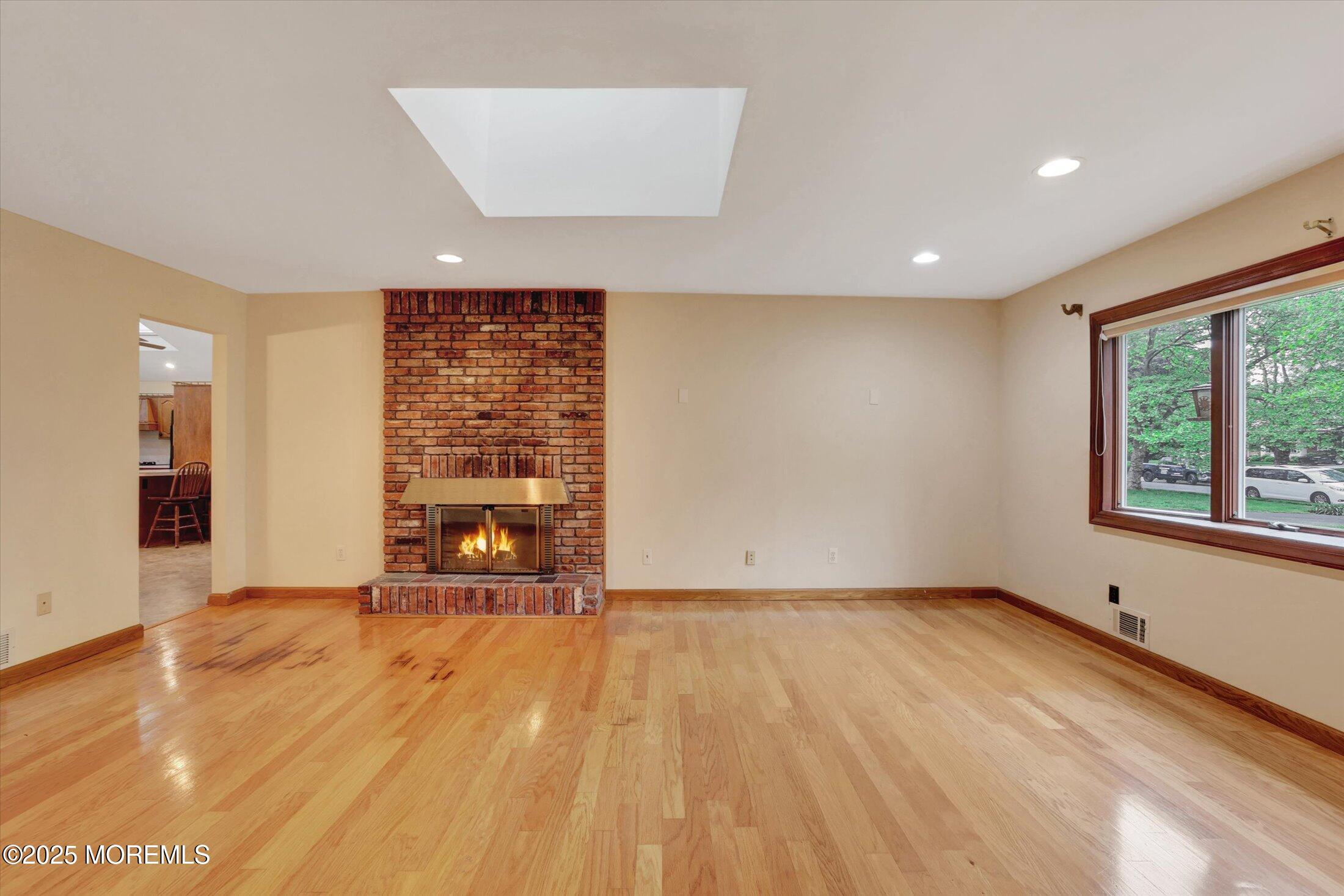 159 Koster Drive Freehold, NJ 07728 - Photo 18 of 37 a view of an empty room with a window and wooden floor